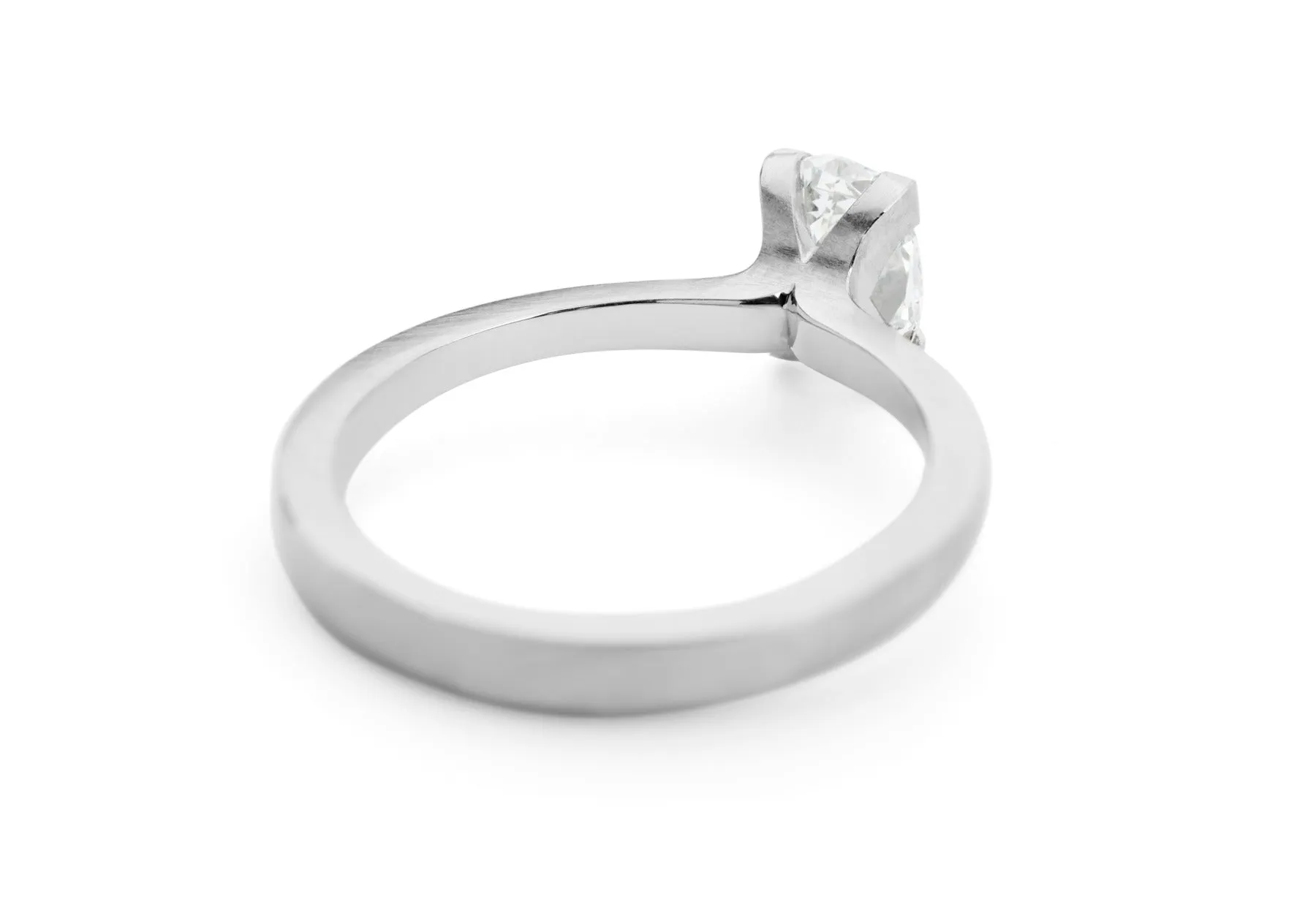 Platinum four claw talon engagement ring with oval white diamond